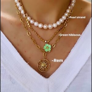 Logan Tay REM necklace. Gold sunburst design.